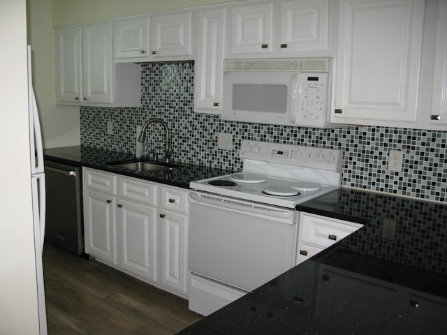 kitchen featuring white appliances, white cabinets, dark wood-style flooring, a sink, and backsplash