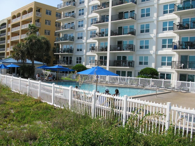 view of swimming pool featuring fence