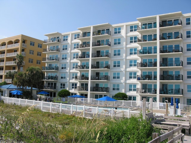 view of property with fence