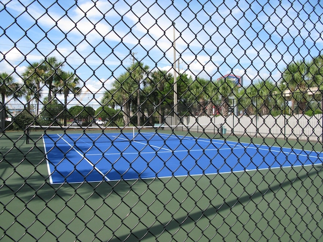 view of sport court featuring fence