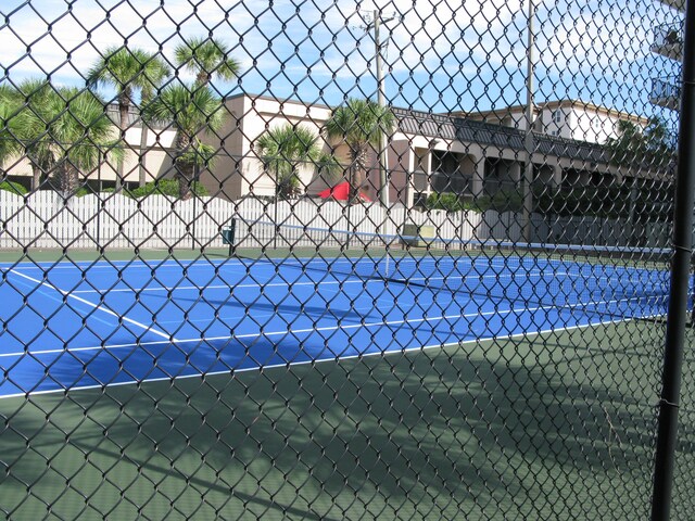 view of tennis court with fence