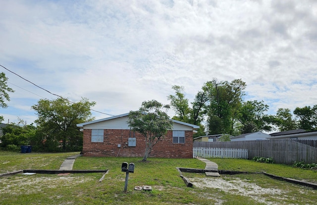 rear view of property featuring a yard