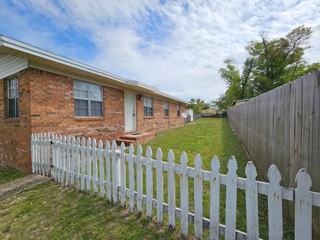 view of side of home featuring a lawn