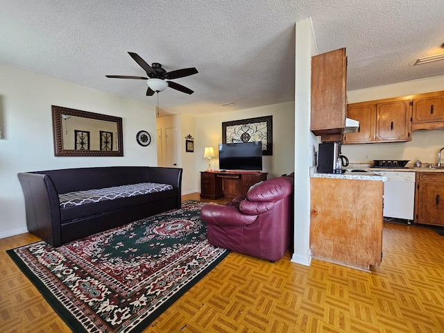 living room with light parquet flooring, a textured ceiling, and ceiling fan