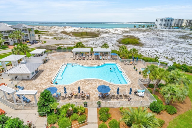 view of pool featuring a patio area and a water view