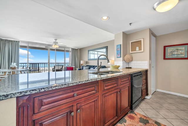 kitchen featuring light tile patterned flooring, black dishwasher, sink, and light stone counters