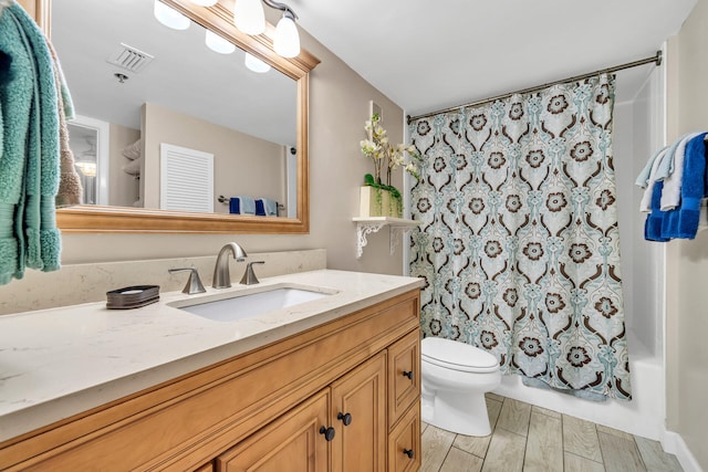 full bathroom featuring shower / bath combo, toilet, and vanity