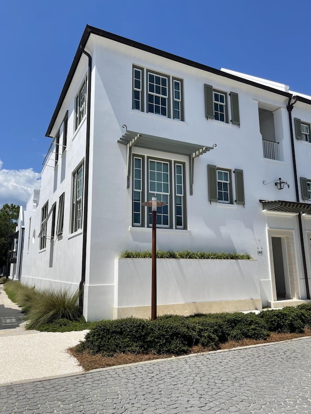 view of side of property with stucco siding