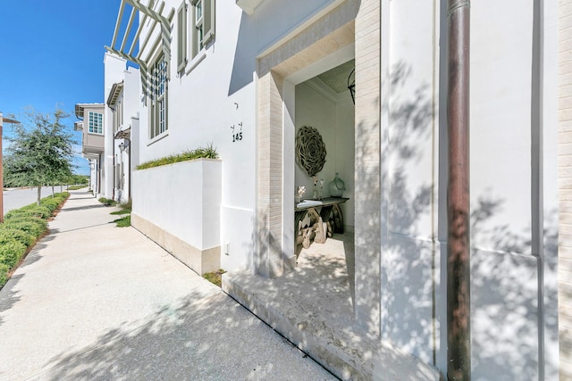 view of side of property featuring stucco siding