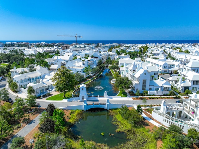 drone / aerial view featuring a residential view and a water view