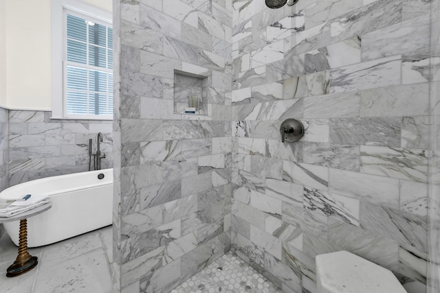 full bathroom with a freestanding tub, tile walls, and tiled shower