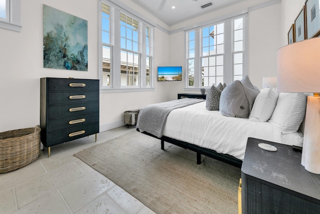 bedroom with baseboards, visible vents, and stone tile floors