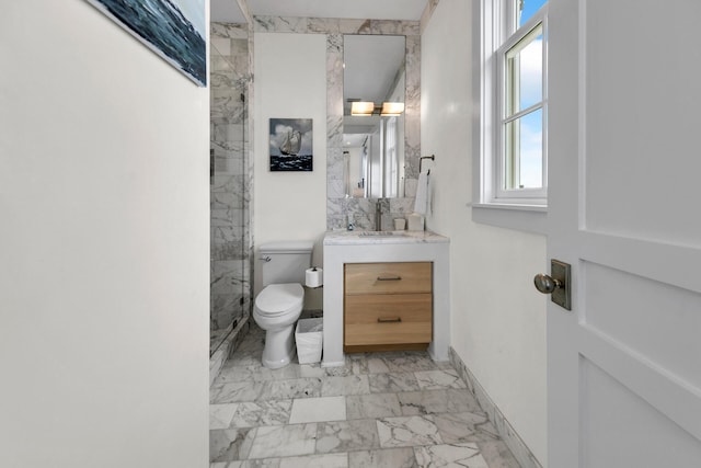 bathroom with marble finish floor, vanity, toilet, and baseboards