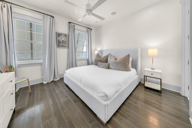 bedroom with a ceiling fan, baseboards, and wood finished floors