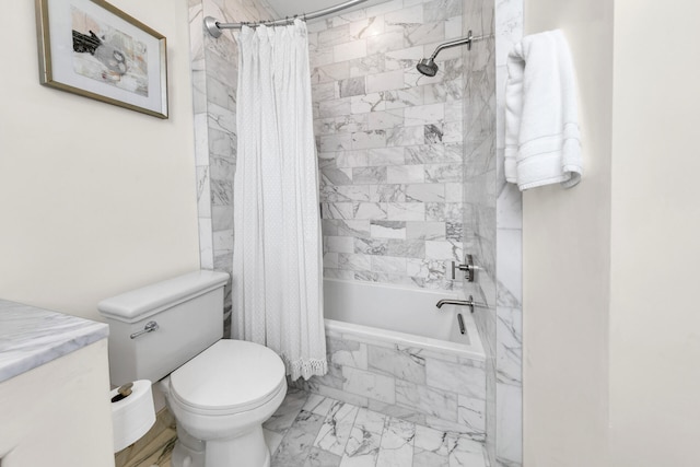 bathroom featuring marble finish floor, tiled shower / bath combo, and toilet