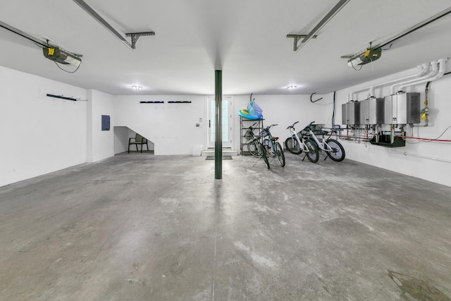 garage with electric panel, bike storage, and a garage door opener