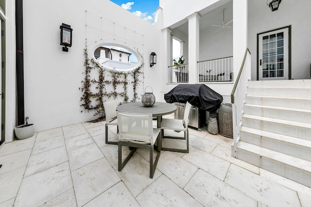 view of patio with outdoor dining area and grilling area