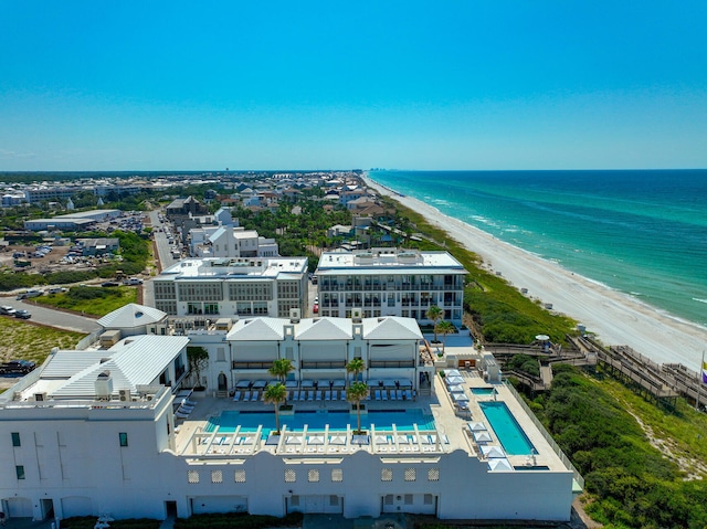 drone / aerial view featuring a water view and a beach view