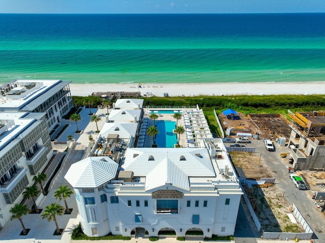 drone / aerial view featuring a water view and a view of the beach