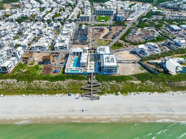 birds eye view of property featuring a water view and a beach view