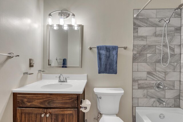 full bathroom with vanity, toilet, and tiled shower / bath combo