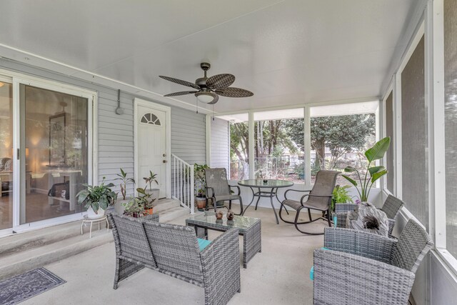 sunroom featuring ceiling fan