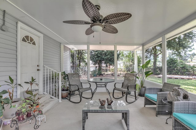 sunroom / solarium featuring ceiling fan