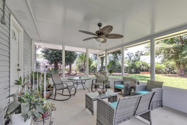 sunroom / solarium with plenty of natural light and ceiling fan