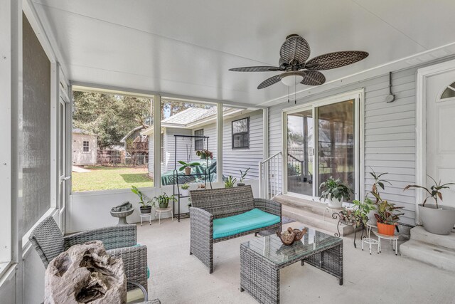 sunroom featuring ceiling fan and a healthy amount of sunlight