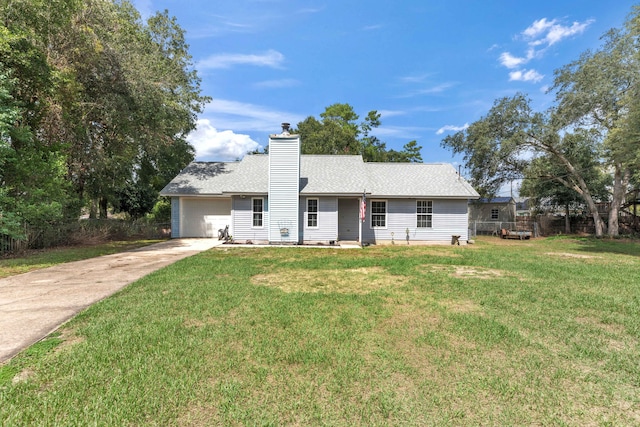 view of front of house with a front lawn and a garage