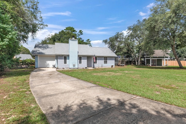 ranch-style house with a garage and a front lawn