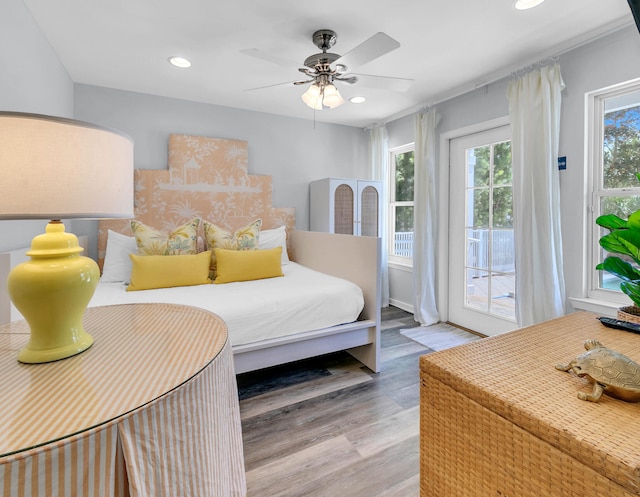 bedroom with access to exterior, ceiling fan, and light hardwood / wood-style floors