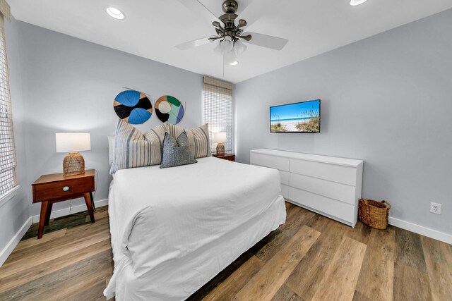 bedroom with hardwood / wood-style floors and ceiling fan