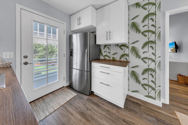 kitchen with dark hardwood / wood-style floors, plenty of natural light, and stainless steel fridge with ice dispenser