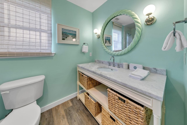 bathroom featuring vanity, toilet, and wood-type flooring