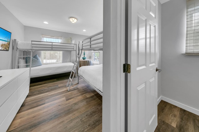 bedroom featuring dark hardwood / wood-style flooring and multiple windows