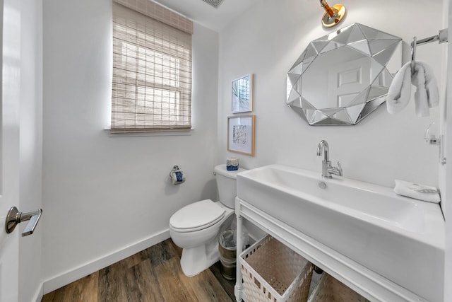 bathroom featuring toilet, hardwood / wood-style flooring, and sink