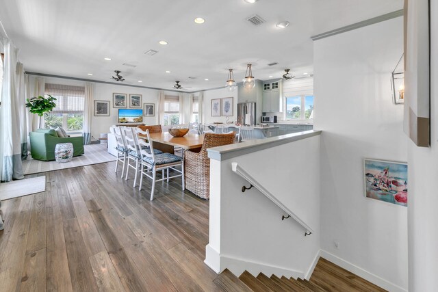 kitchen featuring stainless steel fridge, hardwood / wood-style floors, and ceiling fan