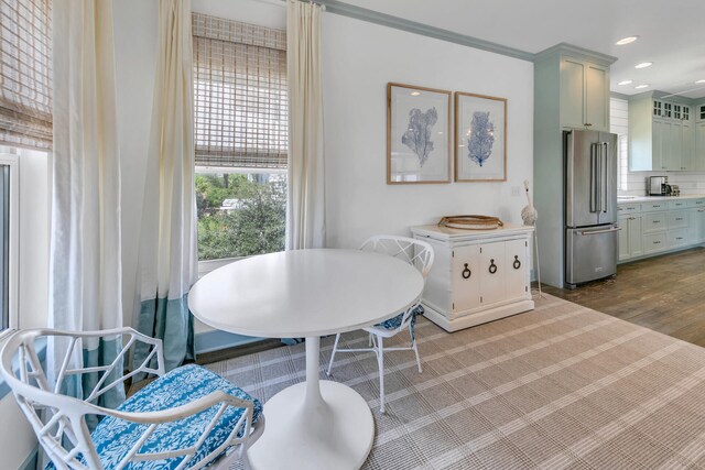 dining space featuring crown molding and hardwood / wood-style flooring