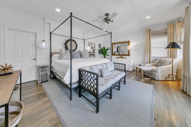 bedroom with ceiling fan, ornamental molding, and hardwood / wood-style floors