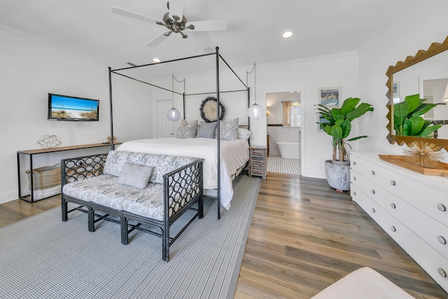 bedroom with ornamental molding, connected bathroom, dark hardwood / wood-style floors, and ceiling fan