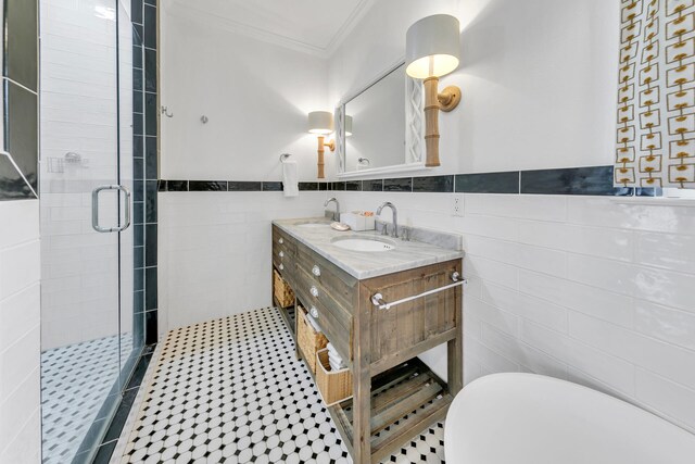 bathroom with crown molding, vanity, tile walls, and an enclosed shower