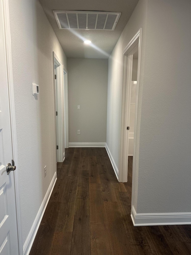 hallway with dark wood-type flooring