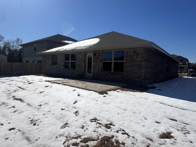 snow covered property with a patio area