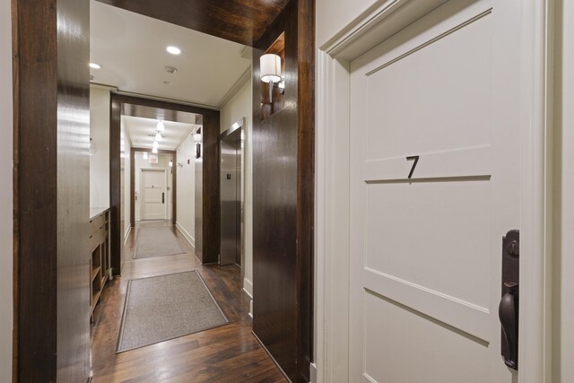 hallway with hardwood / wood-style flooring