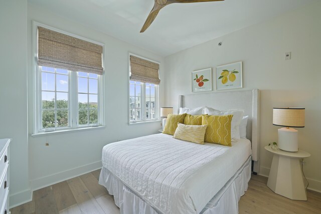 bedroom with ceiling fan and light wood-type flooring