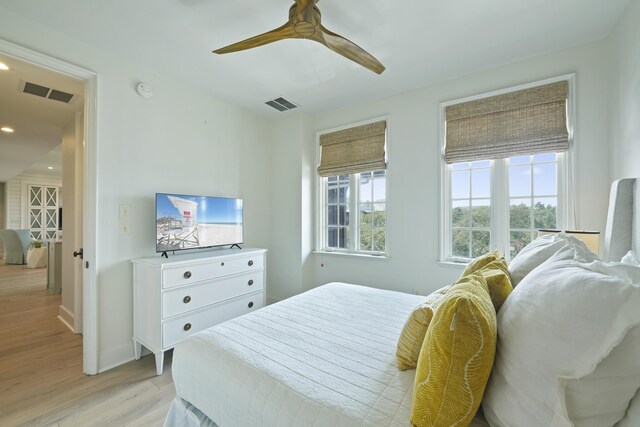 bedroom with ceiling fan and light hardwood / wood-style floors