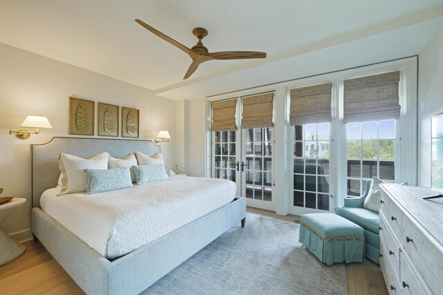 bedroom with ceiling fan, access to outside, light hardwood / wood-style flooring, and french doors