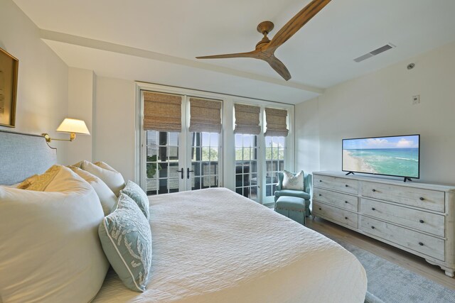 bedroom with hardwood / wood-style flooring, french doors, access to exterior, and ceiling fan