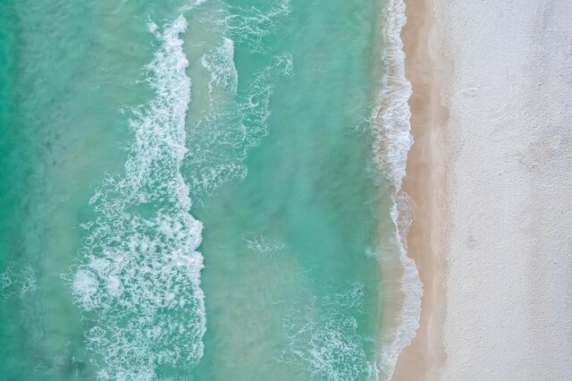 bird's eye view featuring a beach view and a water view